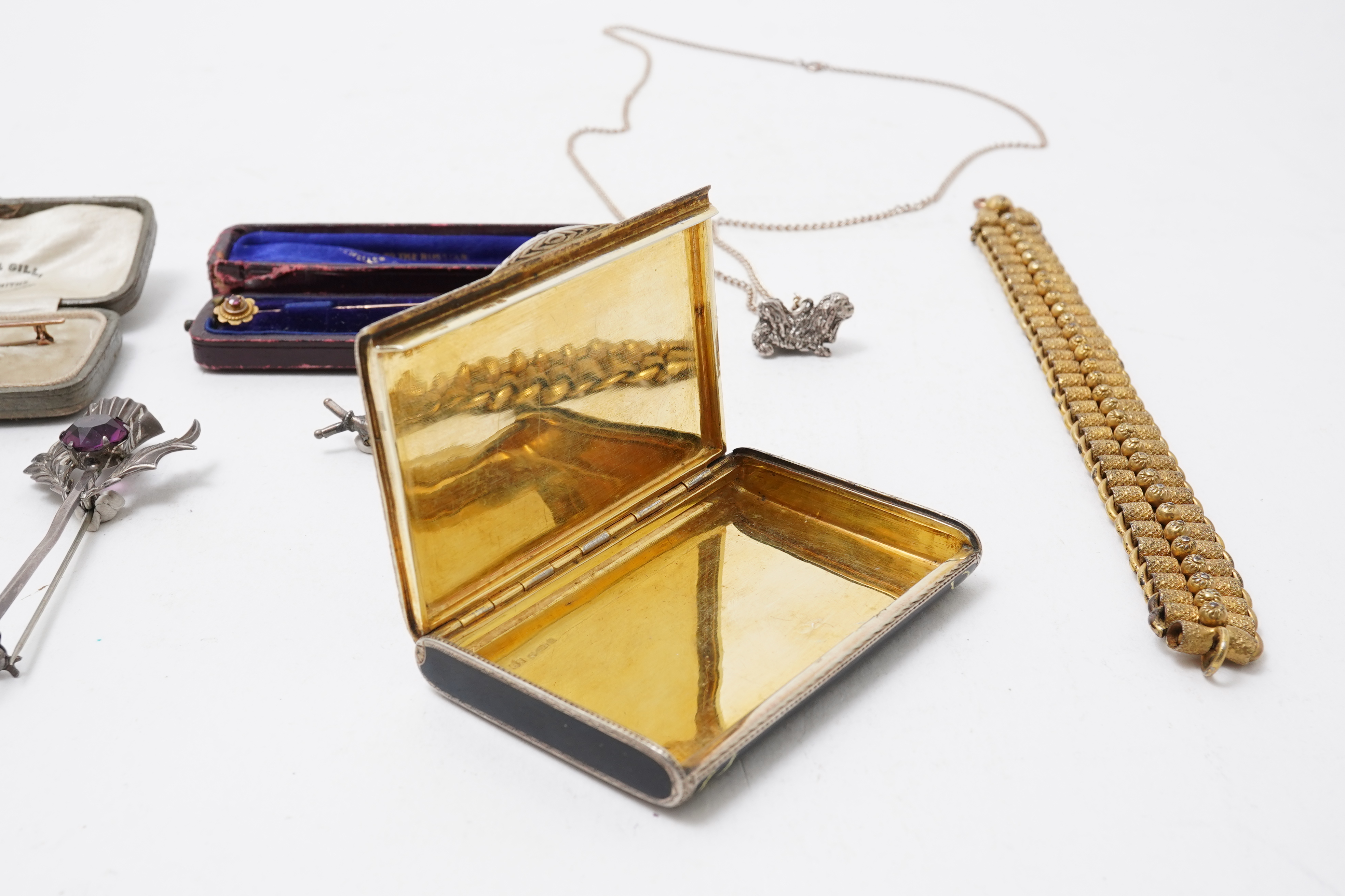 A collection of jewels including an Art Deco silver cigarette case